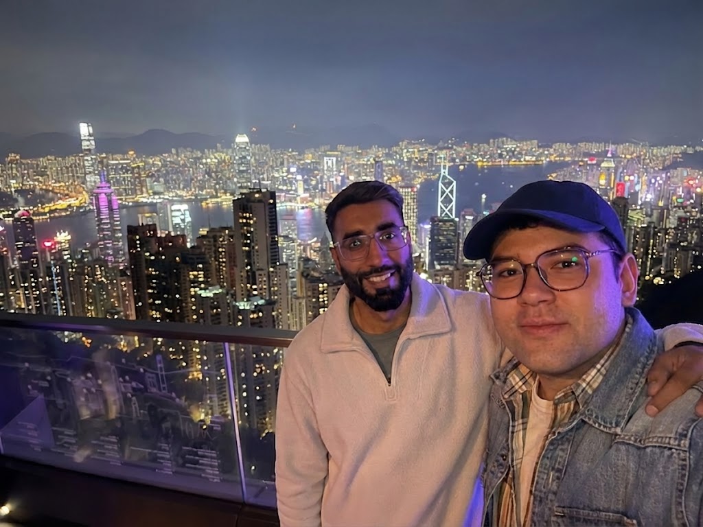 Ananya and Daniel overlooking Hong Kong's skyline from Victoria Peak